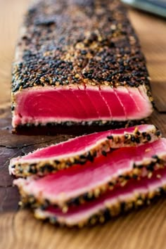 two slices of tuna on a wooden cutting board