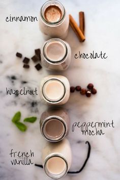 three jars filled with different types of ingredients on top of a marble counter topped with coffee beans and cinnamons