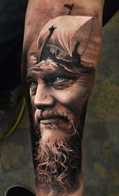 a man's leg with a ship on it