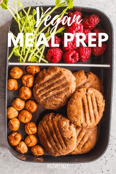 a tray filled with cookies, raspberries and other food items that says vegan meal prep