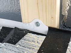 a piece of black and white material is taped to the side of a wooden door