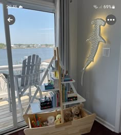 a child's room with a toy boat and bookshelf on the floor