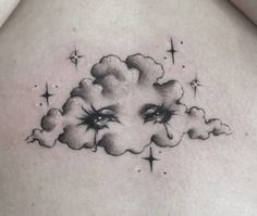 a woman's chest with clouds and eyes on it