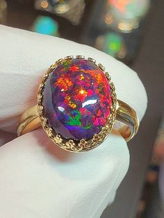 Black fire opal, this one lives up to the name and photographed well. Very colorful and bright with a lovely floral pattern. stone is 12x16mm and 8.64cts. Mounted in a 14k solid gold heavy crown style bezel ring. Multicolor Oval Cabochon Opal Ring, Multicolor Opal Round Ring, Black Cabochon Opal Ring, Iridescent Oval Opal Ring, Multicolor Opal Gemstone Ring, Multicolor Opal Ring, Fire Opal Ring Engagement, Opal Ring Engagement, Heavy Crown