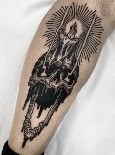 a man's arm with a black and white tattoo on it, depicting an image of a demon