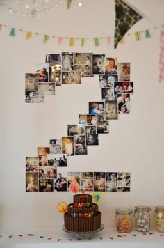 a birthday cake sitting on top of a table next to some pictures and confetti