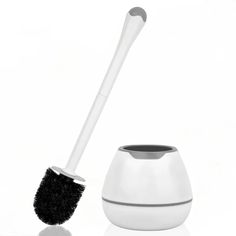 a black and white brush sitting next to a cup