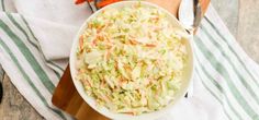 a white bowl filled with coleslaw and carrots