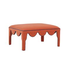 an orange bench with scalloped legs and a curved top