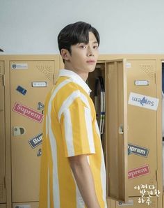 a man standing in front of lockers with stickers on them