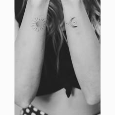 two wrist tattoos with the sun and moon on each arm, in black and white