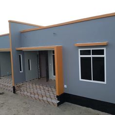 the front of a two story house with an orange and gray trim around the windows