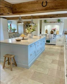 a large kitchen with blue cabinets and an island