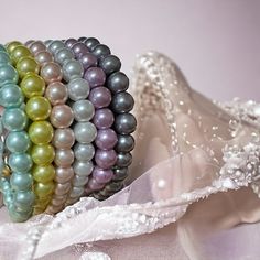 there are many different colored pearls on this bracelet