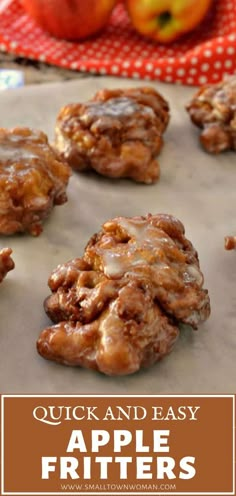 apple fritters on a baking sheet with apples in the background