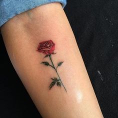 a single rose tattoo on the arm