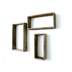 three wooden frames hanging on the wall