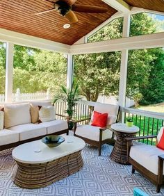 a covered porch with couches and tables on it