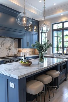 a large kitchen with marble counter tops and blue cabinets, along with four stools