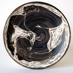 a black and white bowl with swirl designs on it