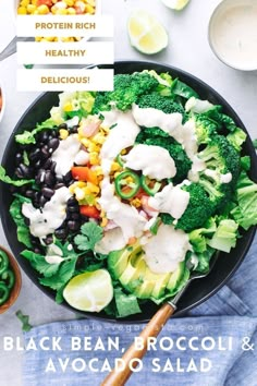 a bowl filled with black bean, broccoli and avocado salad on top of a table