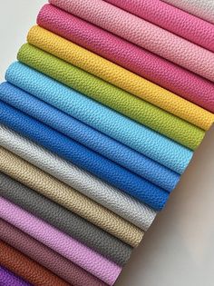 a stack of different colors of fabric