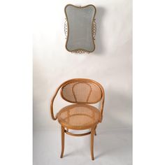 a chair and mirror against a white wall