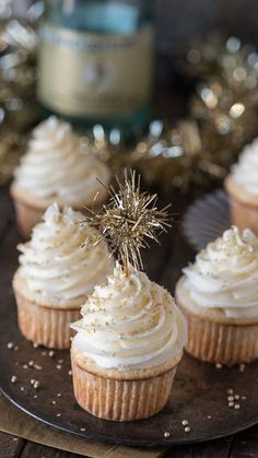 cupcakes with white frosting and a sparkler on top