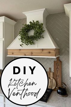 a kitchen with white cabinets and a wreath above the stove top that says diy kitchen vent hood