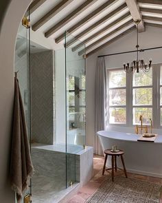 a bathroom with a tub, sink and window in it's centerpieces