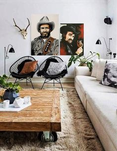 a living room filled with furniture and pictures on the wall above it's coffee table