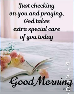 an open book sitting on top of a bed next to flowers and the words just checking on you and praying, god takes extra special care of you today