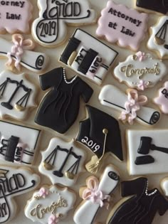 decorated cookies are arranged in the shape of graduation caps, gowns, and shoes