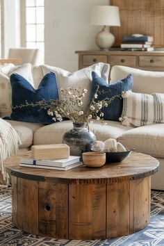 a living room filled with furniture and a coffee table in front of a couch on top of a rug