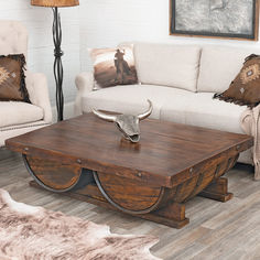 a living room filled with furniture and a cow skull on top of a coffee table