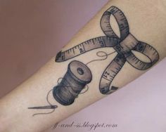 a tattoo with scissors, thread and measuring tape