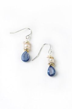 Elegant pearls with rich blue kyanite create both a dressy and laid back pair of handmade dangle silver and pearl earrings for women! Simple pearls with kyanite briolette drop are fun for everyday wear. Sterling silver Freshwater pearl, kyanite Approx 1.5" length Our unique handcrafted designer jewelry for women is made in America, each design created individually in our personal design studio in Floyd VA USA Simple Gemstone Earrings, Diy Simple Earrings, Handmade Drop Earrings, Everyday Jewelry Simple, Diy Earrings Dangle, Floyd Va, Dangle Silver Earrings, Handmade Pearl Jewelry, Dark Blue Earrings