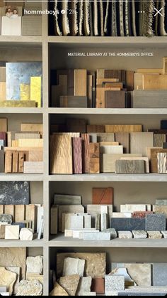 the shelves are filled with different types of wood and marbles, including granite blocks