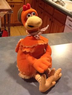 an orange stuffed animal sitting on top of a counter