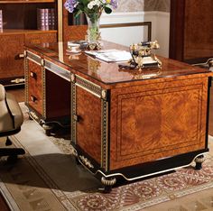 a wooden desk sitting on top of a rug next to a chair