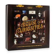 the house of curiosites board game is in its wooden box and has skeleton heads on it