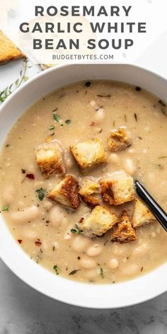 a bowl of soup with croutons in it and the words rosemary garlic white bean soup