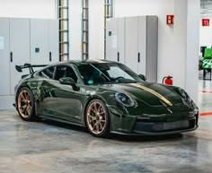 a green sports car parked in a garage