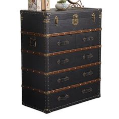 an old trunk with three drawers and two books on top is sitting in front of a white background