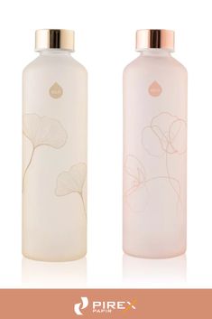 two bottles with flowers on them sitting next to each other