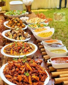 a table filled with lots of different types of food on top of white plates next to each other