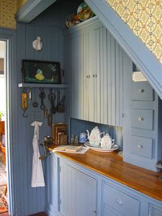 a kitchen with blue walls and wooden counter tops