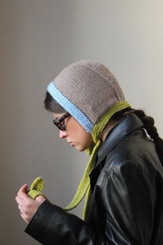 a woman wearing a knitted hat and scarf