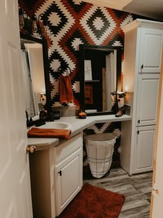 the bathroom is decorated in black, white and orange colors with an interesting pattern on the wall