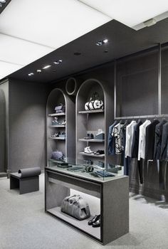 a clothing store with black walls and shelves